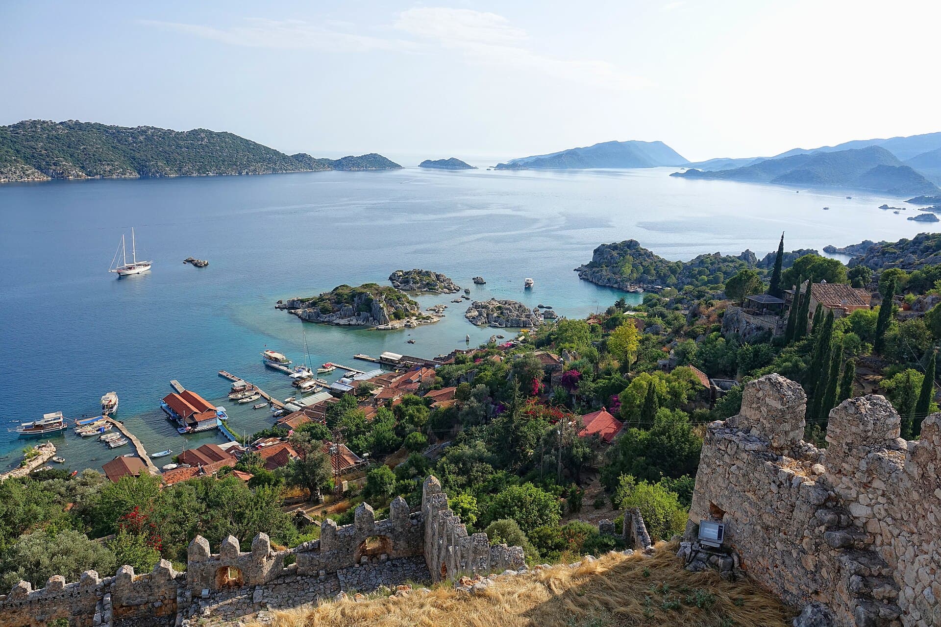 Kekova Island and the waters of Kekova Sound seen from the Simena fortress above Kaleköy village, Antalya province, Turkey, 2019. Illustrative view of the area; this is not the wreck site. Photo: Bjørn Christian Tørrissen, via Wikimedia Commons (CC BY-SA 4.0). Source page: https://commons.wikimedia.org/wiki/File:Kekova_island_and_Kalekoey_village.jpg