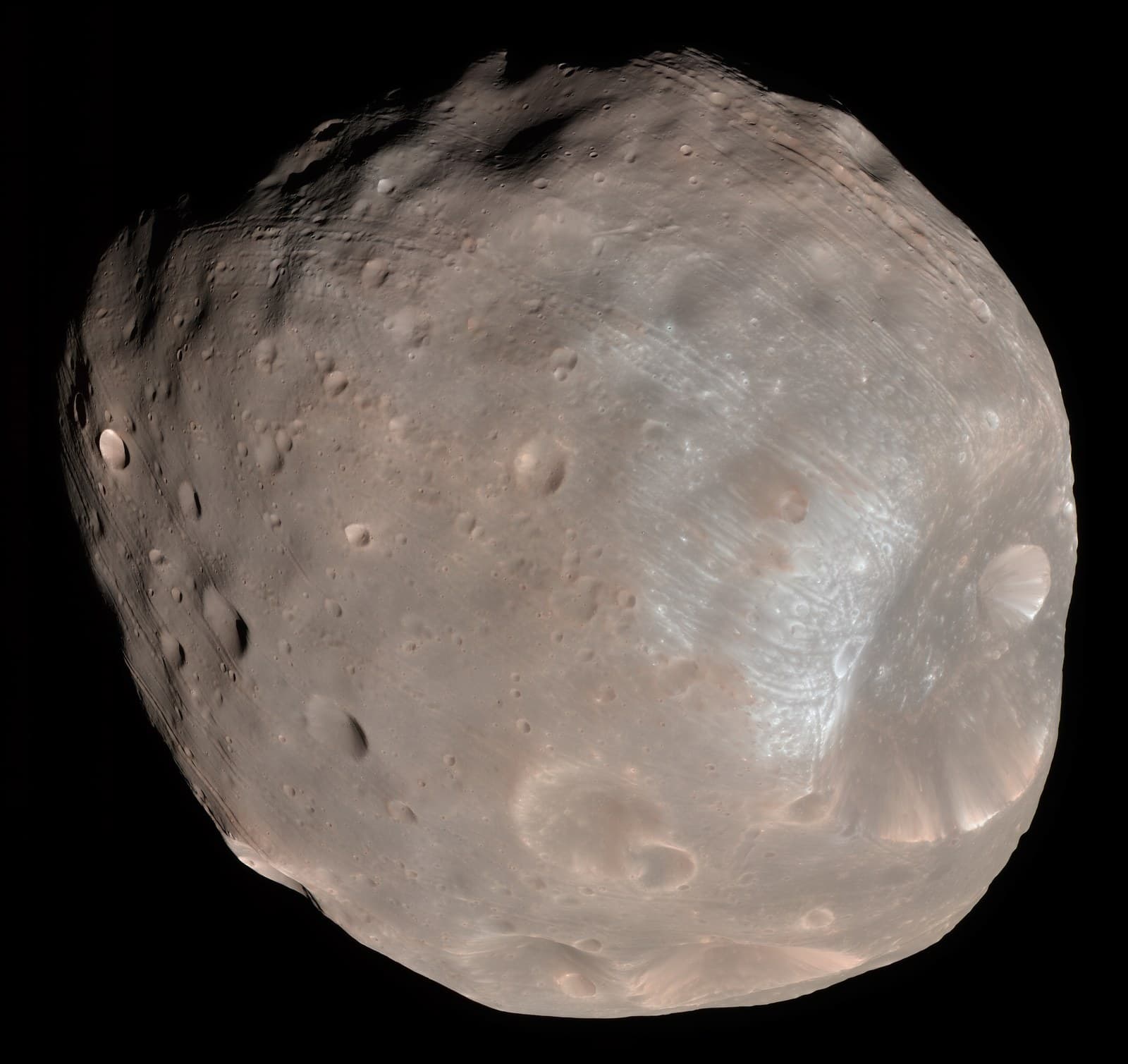 Phobos, the larger moon of Mars, in enhanced color, imaged by the HiRISE camera on NASA's Mars Reconnaissance Orbiter on 23 March 2008. Image: NASA/JPL-Caltech/University of Arizona, public domain, via Wikimedia Commons. Source page: https://commons.wikimedia.org/wiki/File:Phobos_colour_2008.jpg